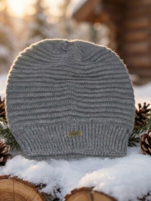 Unisex rib-knit winter hat in rust brown on snowy outdoor setting.