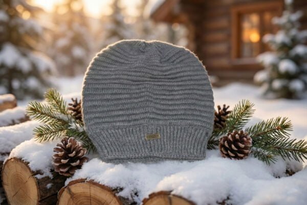 Unisex rib-knit winter hat in rust brown on snowy outdoor setting.