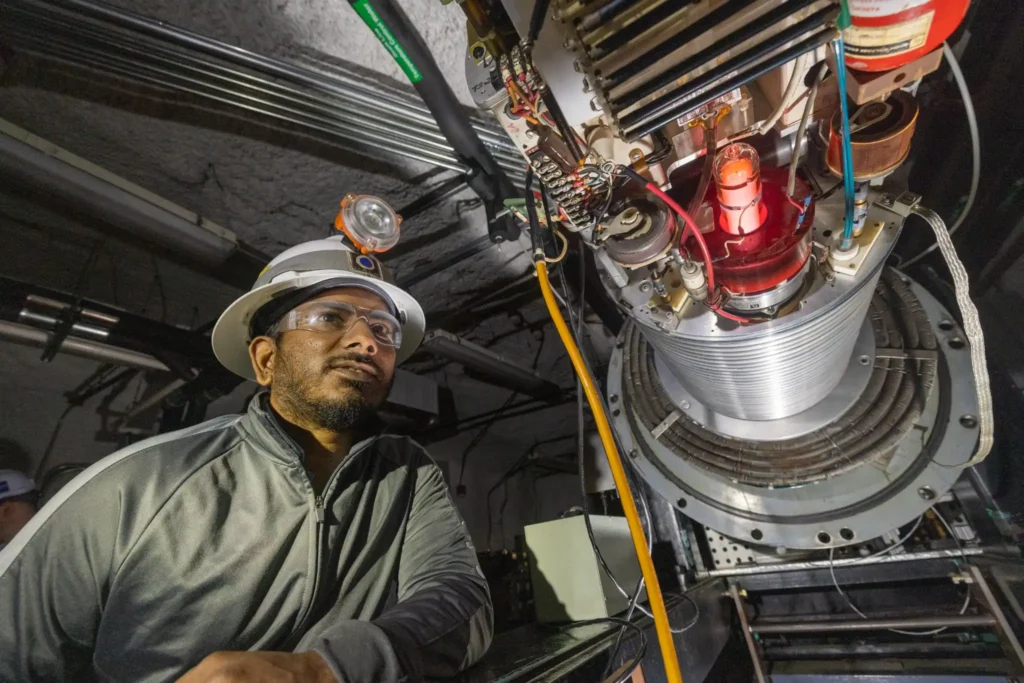 A researcher monitors the CASPAR accelerator during first plasma operations 4,850 feet underground at the Sanford Underground Research Facility, where low-energy stellar fusion reactions are recreated.