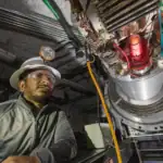 Scientist working on stellar fusion experiment at high altitude.